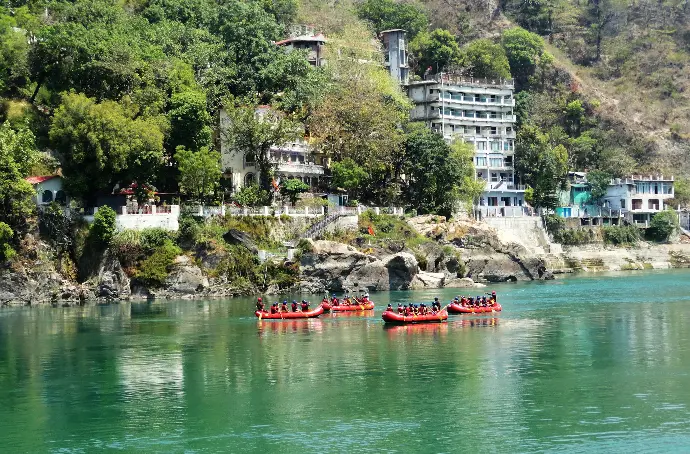 people riding red kayak on river during daytime